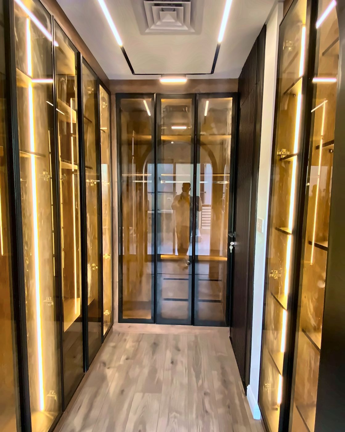 Dressing corridor with LED-lit glass wardrobes, New Giza
