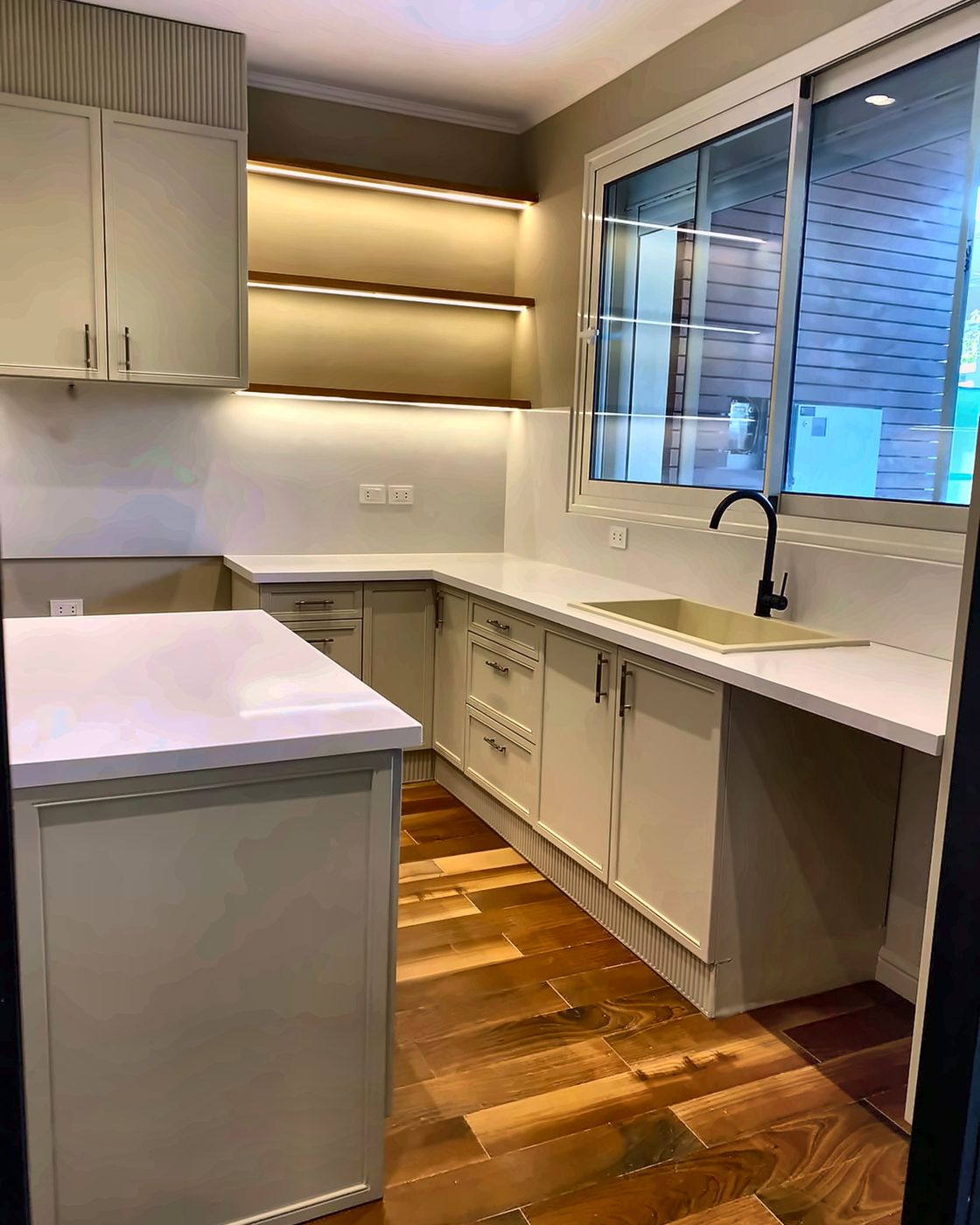 Kitchen with window, undermount sink and lit shelves, New Giza
